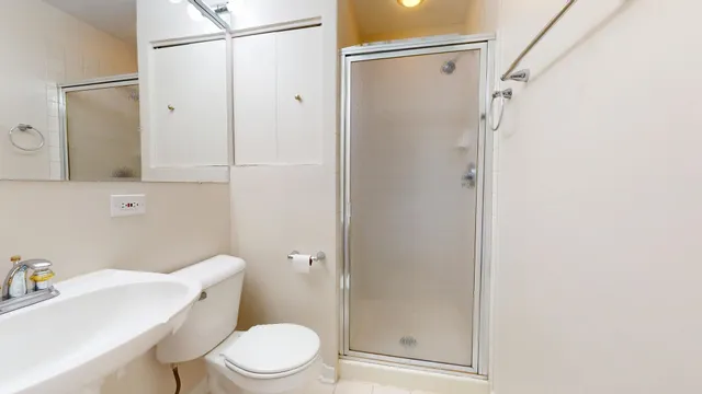 a white toilet sitting next to a bathroom sink