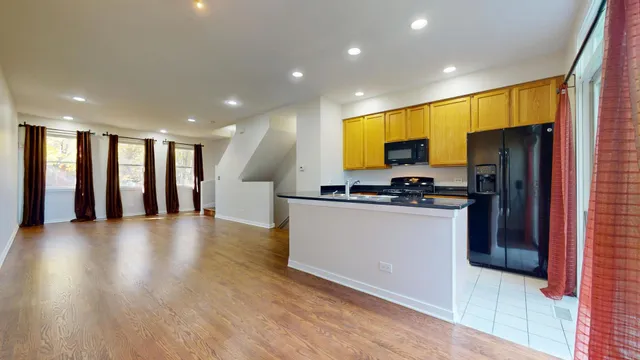 a kitchen with a refrigerator and a stove top oven