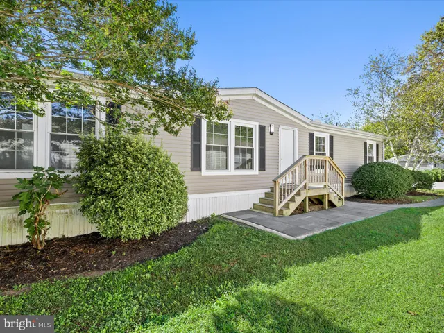 a view of a house with backyard sitting area and garden