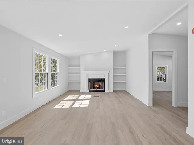 a kitchen with white cabinets appliances and sink