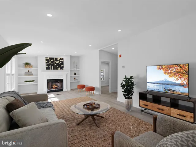 an empty room with windows and a fireplace