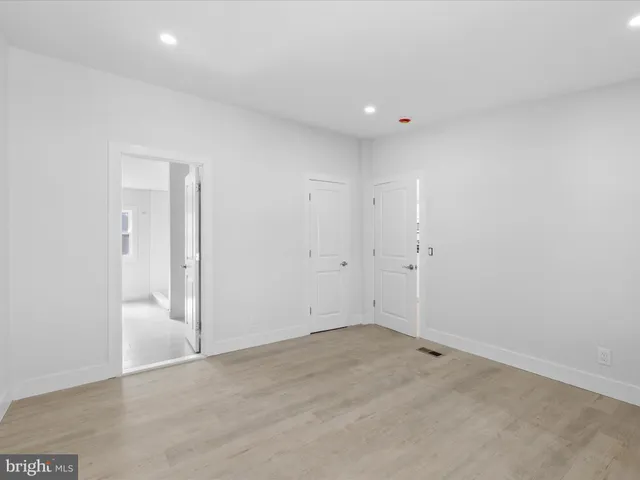 a bedroom with a large bed and a potted plant