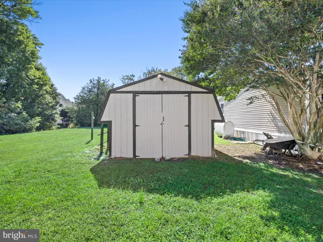 a backyard of a house with potted plants and a bench