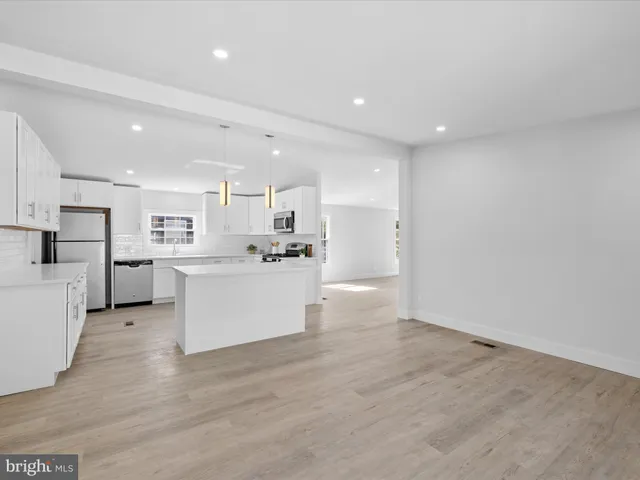 a view of a field of grass and trees