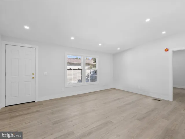 a view of kitchen with kitchen island white cabinets and refrigerator