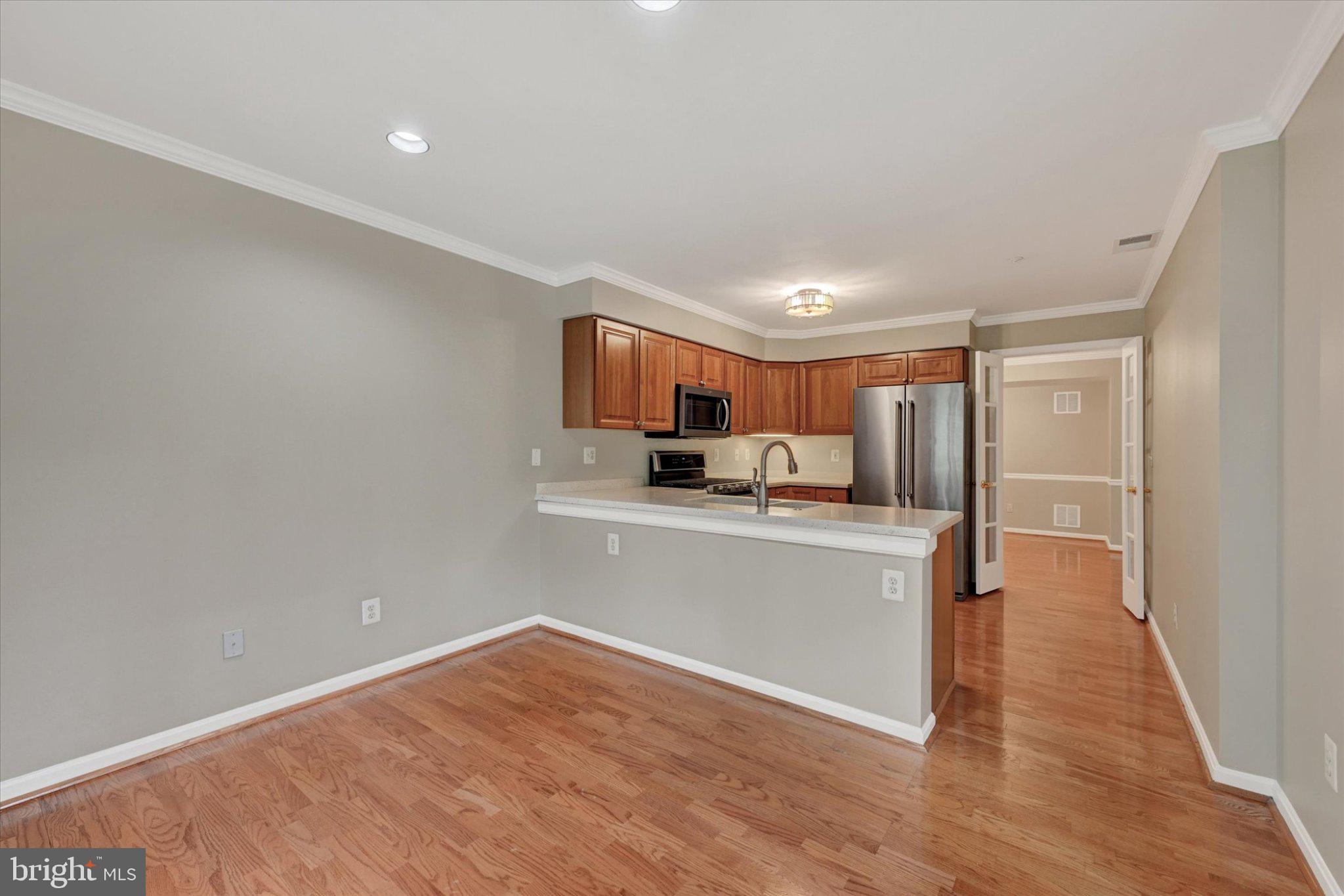 12310 Rosslare Ridge Road, Unit 405 Lutherville-Timonium, MD 21093 - Photo 16 of 30 Modern kitchen with warm wood accents.