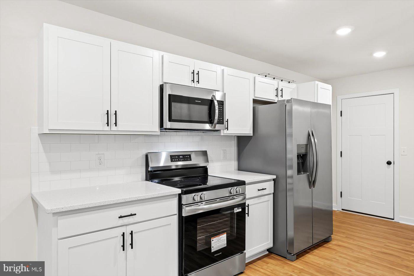736 Circle Lane Colonial Beach, VA 22443 - Photo 19 of 40 a kitchen with stainless steel appliances a stove microwave and refrigerator