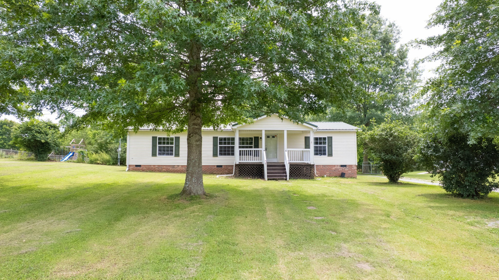 2132 Lasea Road Spring Hill, TN 37174 - Photo 16 of 26 a view of a house with a big yard and large trees