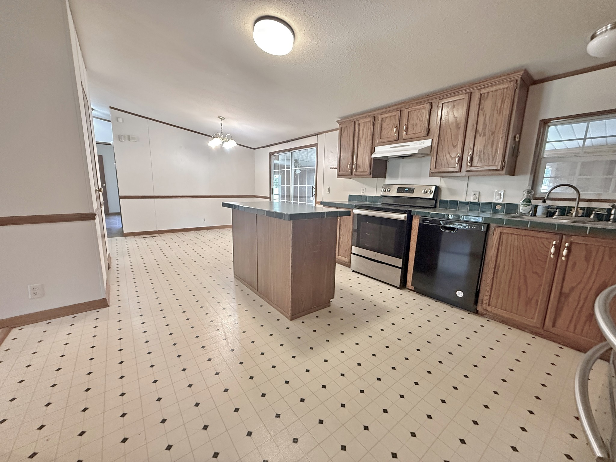2132 Lasea Road Spring Hill, TN 37174 - Photo 5 of 26 a kitchen with a sink a stove a refrigerator and cabinets