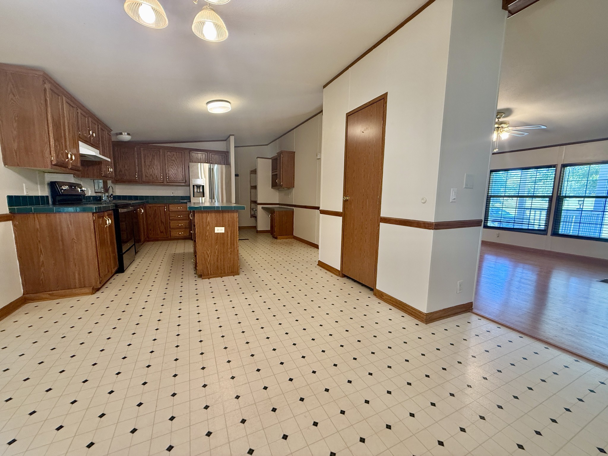2132 Lasea Road Spring Hill, TN 37174 - Photo 8 of 26 a kitchen with a sink a refrigerator and wooden floor
