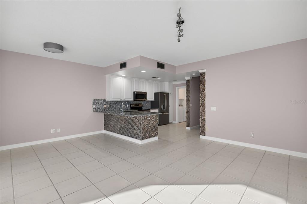 3518 Zanzibar Way Naples, FL 34119 - Photo 11 of 44 a kitchen with stainless steel appliances a refrigerator sink and microwave