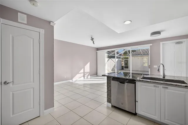a kitchen with granite countertop a sink and cabinets