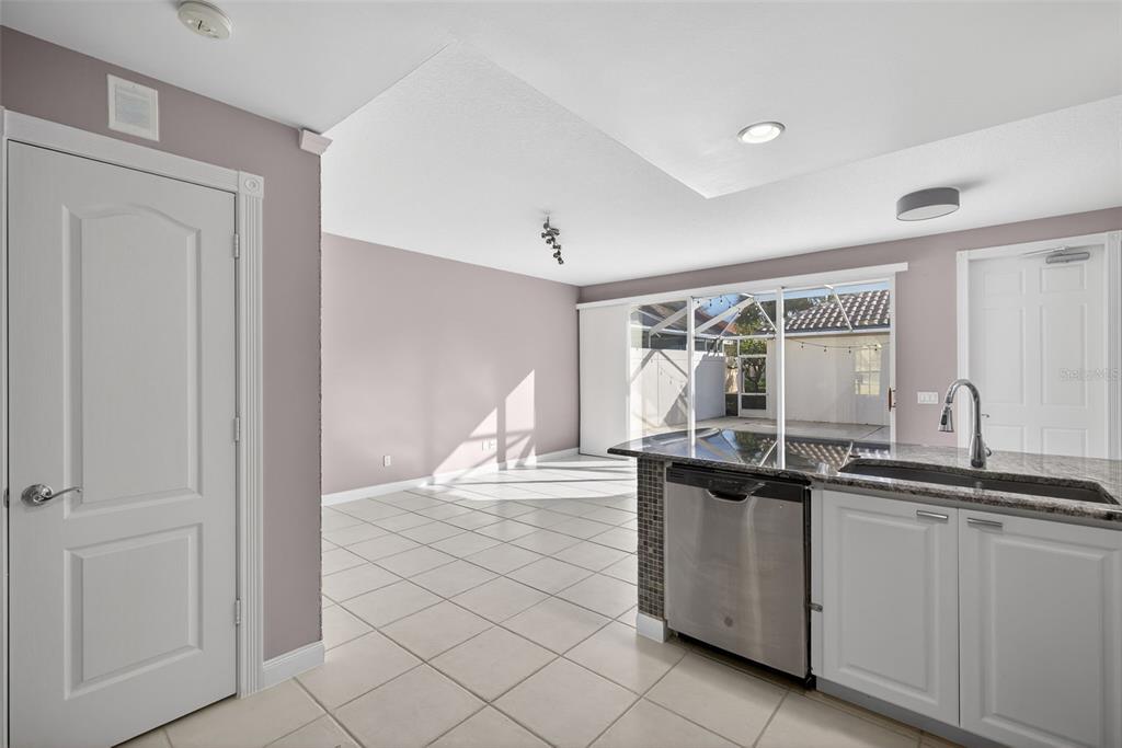 3518 Zanzibar Way Naples, FL 34119 - Photo 14 of 44 a kitchen with granite countertop a sink and cabinets