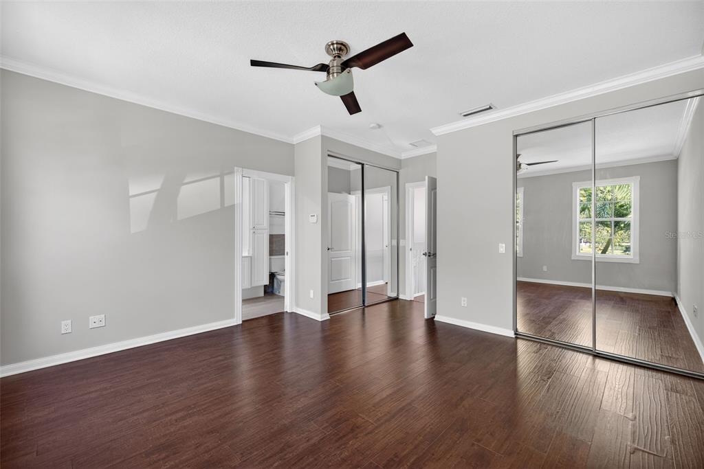 3518 Zanzibar Way Naples, FL 34119 - Photo 18 of 44 a view of an empty room with window and wooden floor