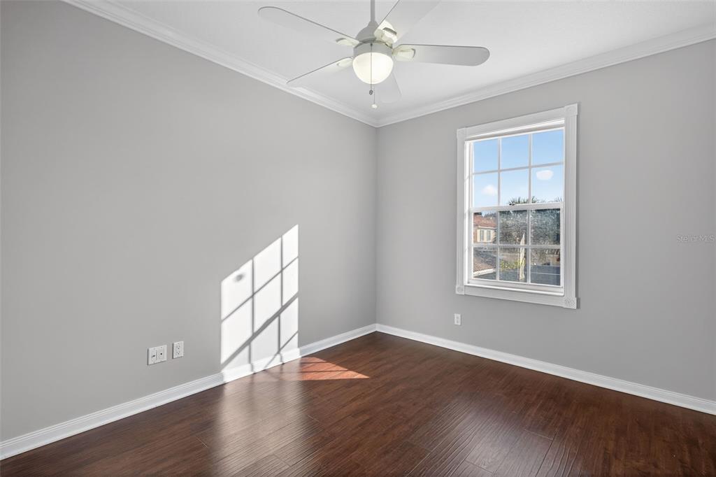3518 Zanzibar Way Naples, FL 34119 - Photo 21 of 44 a view of an empty room with wooden floor and a window