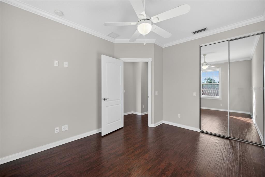 3518 Zanzibar Way Naples, FL 34119 - Photo 22 of 44 a view of an empty room with wooden floor