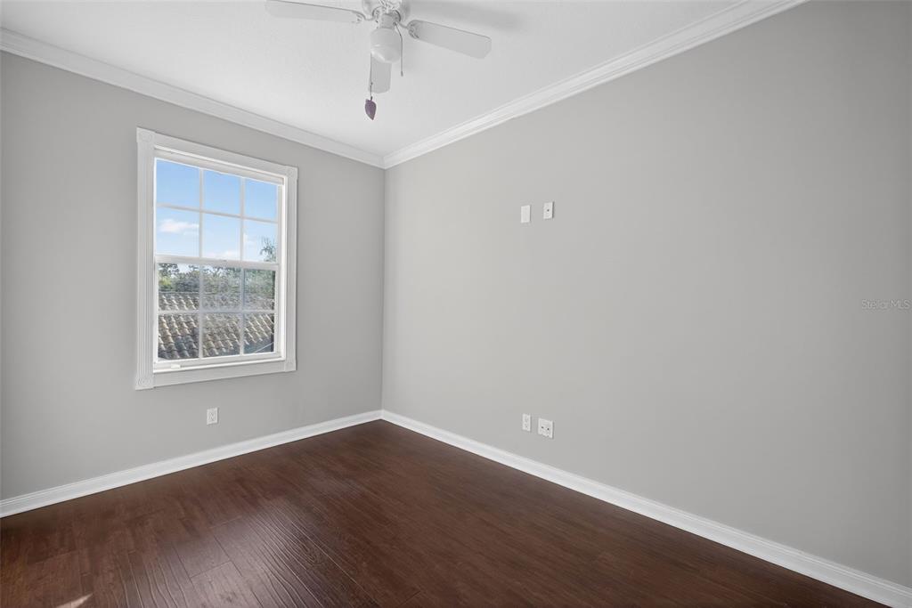 3518 Zanzibar Way Naples, FL 34119 - Photo 23 of 44 a view of an empty room with wooden floor and a window