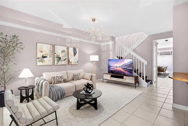 a living room with furniture and a chandelier