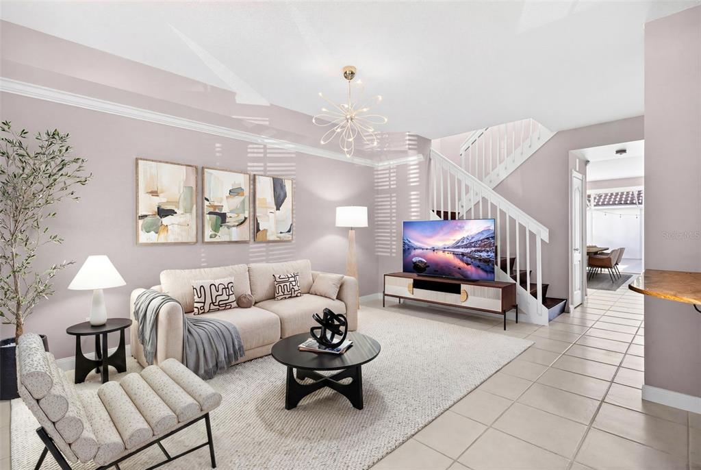 3518 Zanzibar Way Naples, FL 34119 - Photo 4 of 44 a living room with furniture and a chandelier