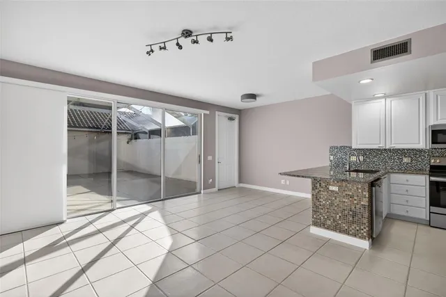 a spacious bathroom with a granite countertop sink a mirror and shower