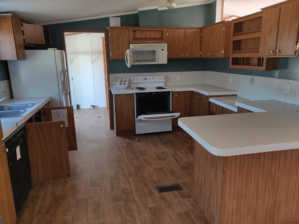 411 Scott Road Elko, GA 31025 - Photo 17 of 27 a kitchen with stainless steel appliances a stove refrigerator sink and cabinets
