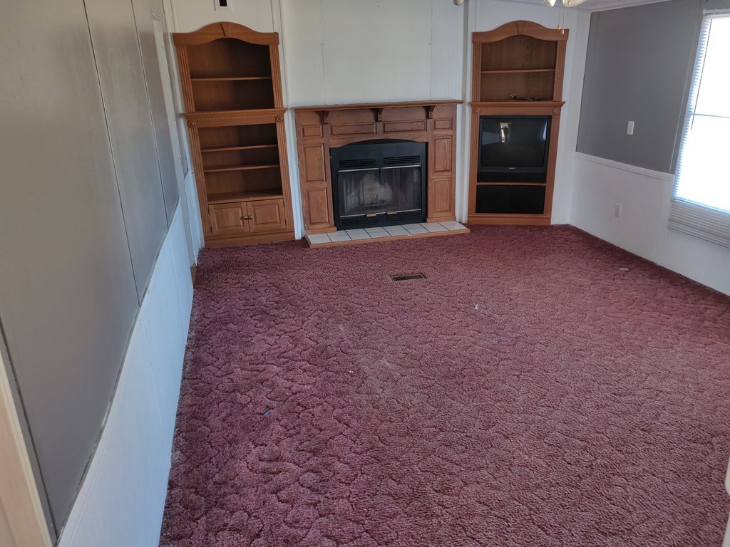 411 Scott Road Elko, GA 31025 - Photo 18 of 27 an empty room with a fireplace and cabinet