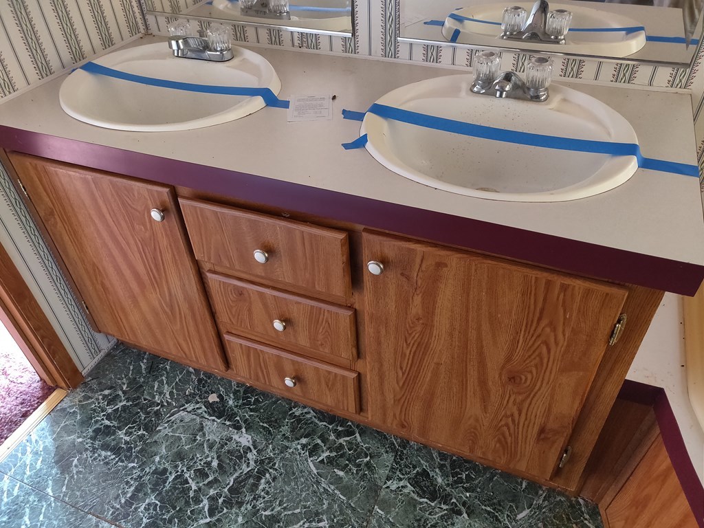 411 Scott Road Elko, GA 31025 - Photo 21 of 27 a bathroom with a sink a mirror and vanity