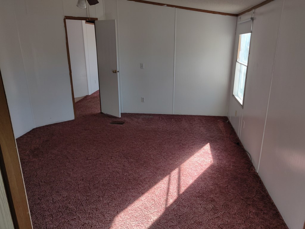 411 Scott Road Elko, GA 31025 - Photo 22 of 27 an empty room with wooden floor and windows
