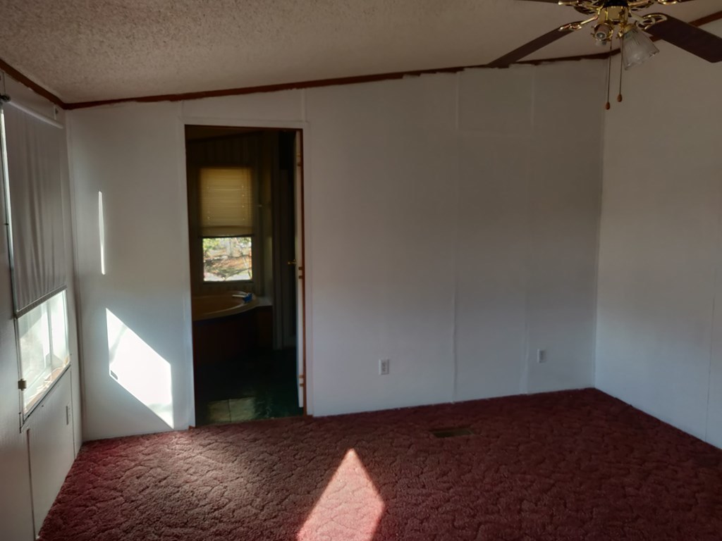 411 Scott Road Elko, GA 31025 - Photo 24 of 27 a view of a bedroom with wooden floor and closet