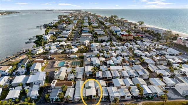 an aerial view of a building with an ocean view