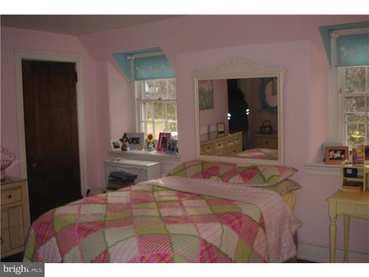 1025 Coates Road Jenkintown, PA 19046 - Photo 19 of 23 a bedroom with a bed and a large mirror