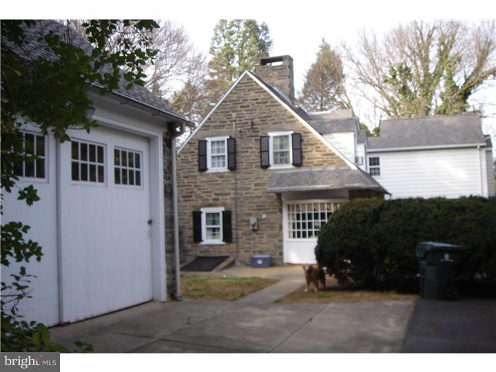 1025 Coates Road Jenkintown, PA 19046 - Photo 22 of 23 a view of a yard in front of a white house with large windows