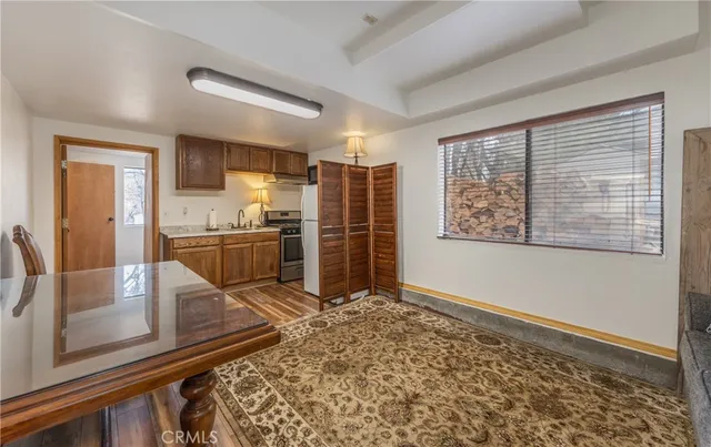 a view of a room with wooden floor and a window