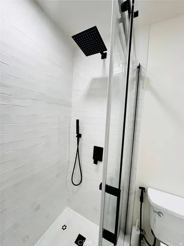 a bathroom with a shower and toilet