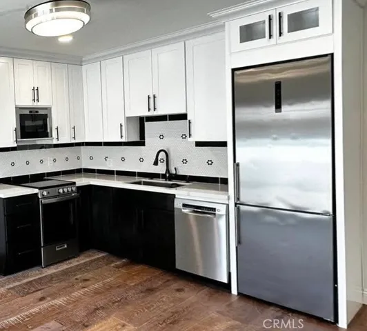 a kitchen with stainless steel appliances granite countertop a refrigerator and a stove