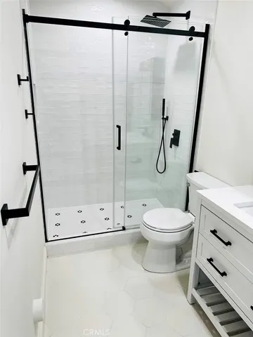 a bathroom with a shower a toilet and a shower