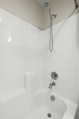 a living room with furniture a ceiling fan and a window