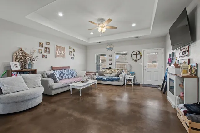 a living room with furniture and a flat screen tv
