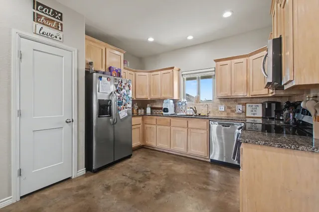 a kitchen with granite countertop white cabinets and sink