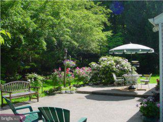 291 Creek Road Doylestown, PA 18901 - Photo 5 of 6 a view of a table and chairs under an umbrella