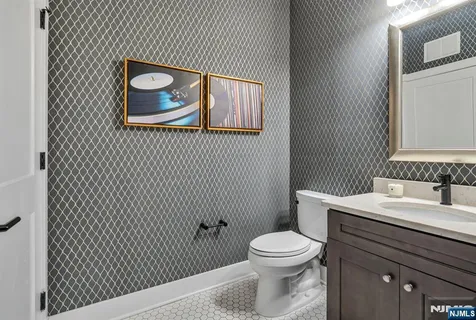 a bathroom with a toilet a sink and mirror