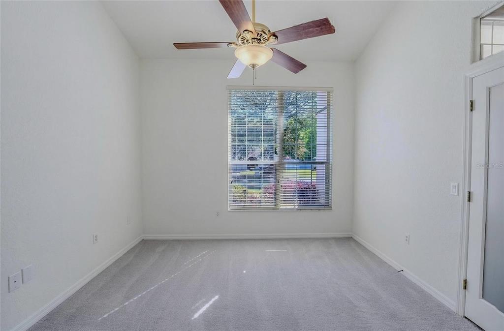 6598 Southeast 11th Loop Ocala, FL 34472 - Photo 15 of 49 an empty room with a window and a fan