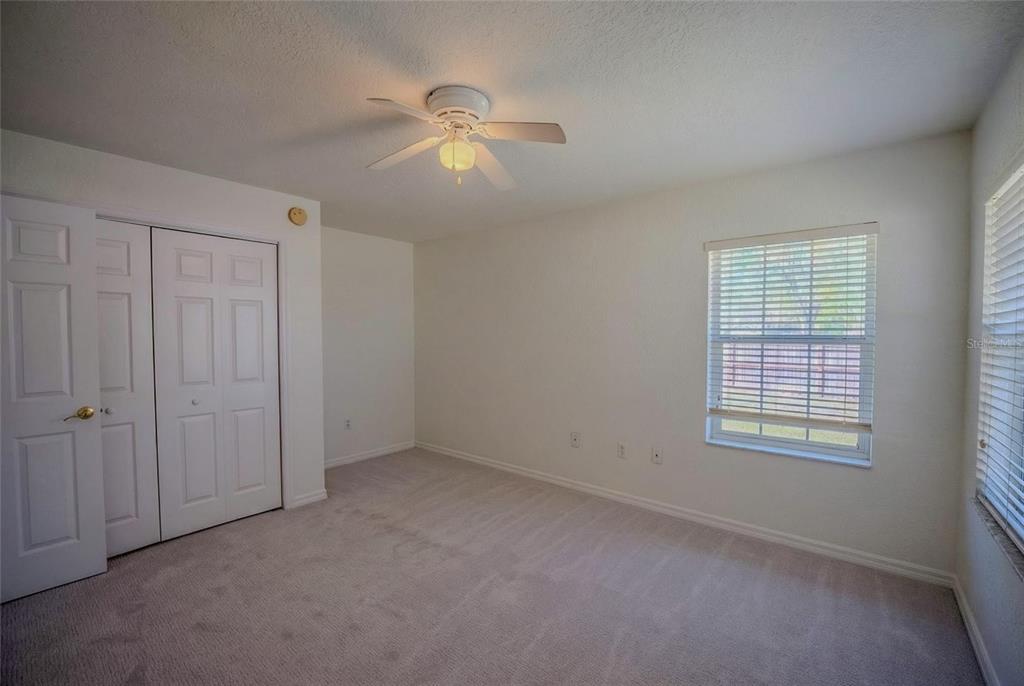 6598 Southeast 11th Loop Ocala, FL 34472 - Photo 18 of 49 an empty room with windows and fan