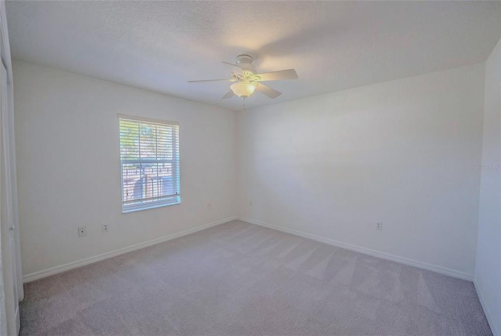 6598 Southeast 11th Loop Ocala, FL 34472 - Photo 19 of 49 an empty room with windows and fan