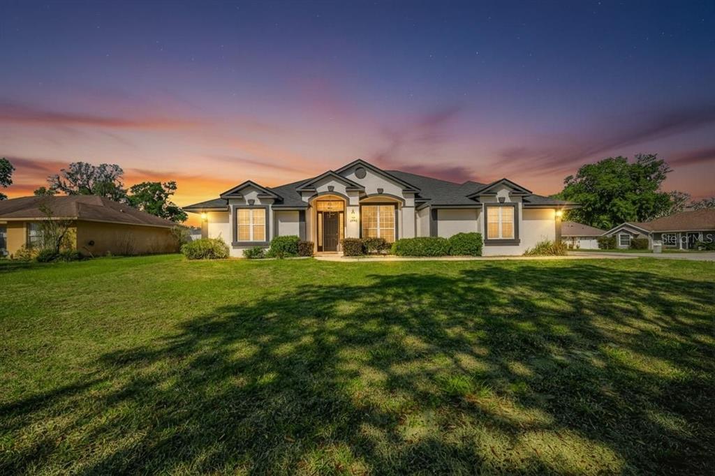 6598 Southeast 11th Loop Ocala, FL 34472 - Photo 32 of 49 a front view of a house with garden