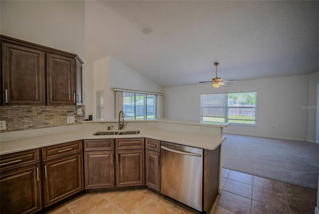 6598 Southeast 11th Loop Ocala, FL 34472 - Photo 34 of 49 a kitchen with stainless steel appliances granite countertop a sink and a stove
