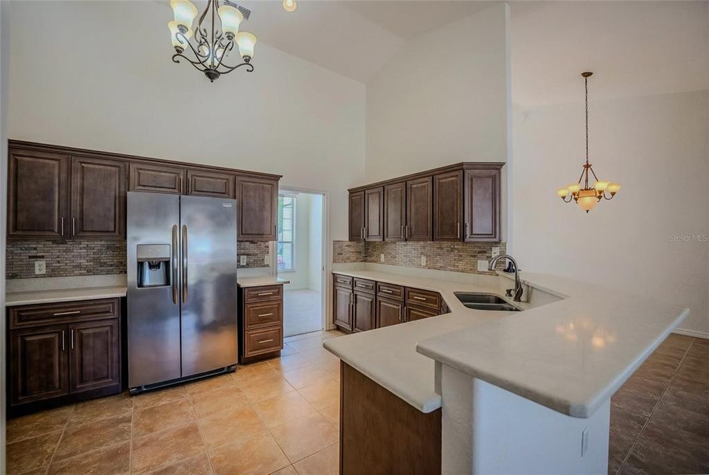 6598 Southeast 11th Loop Ocala, FL 34472 - Photo 36 of 49 a kitchen with stainless steel appliances granite countertop a sink stove and refrigerator