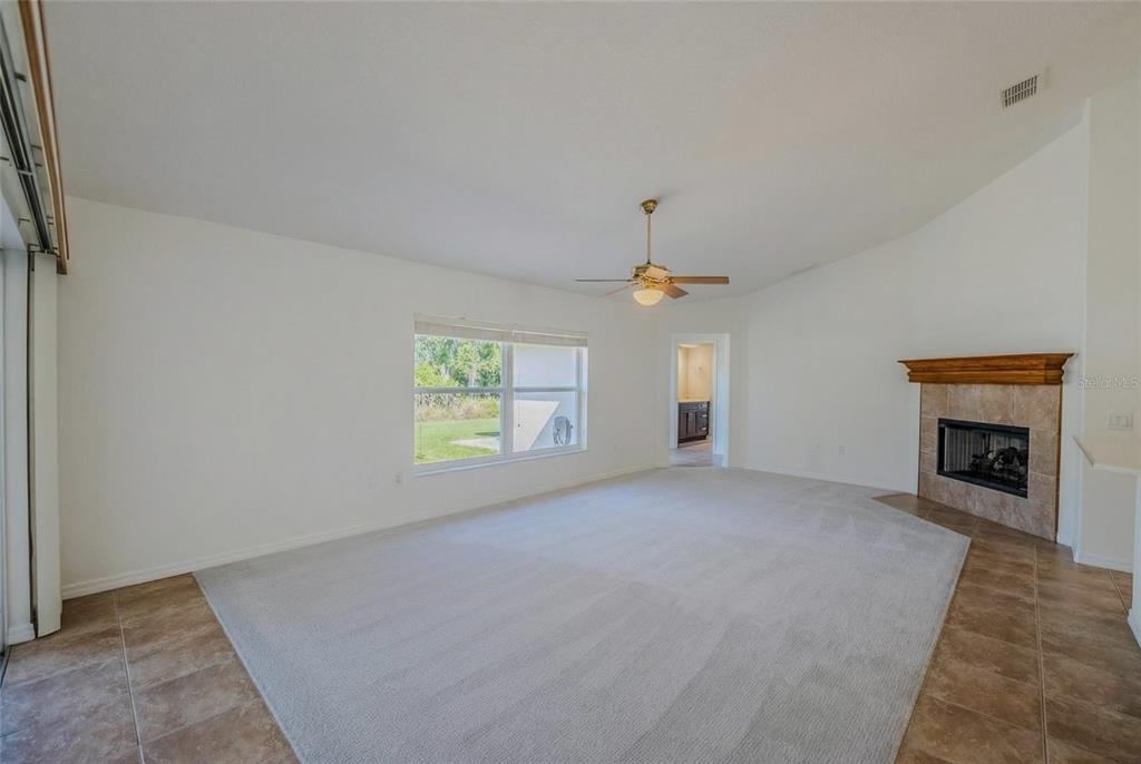 6598 Southeast 11th Loop Ocala, FL 34472 - Photo 37 of 49 an empty room with windows and fireplace