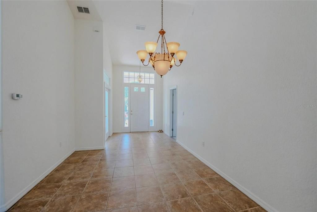 6598 Southeast 11th Loop Ocala, FL 34472 - Photo 38 of 49 a view of a hallway with a chandelier fan