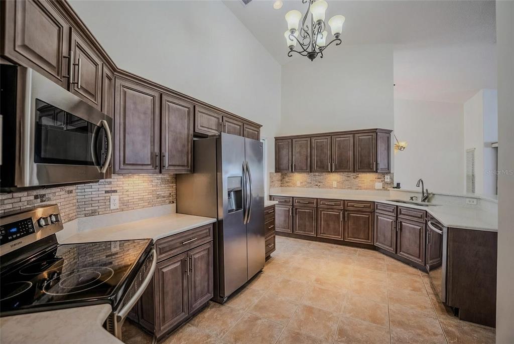 6598 Southeast 11th Loop Ocala, FL 34472 - Photo 4 of 49 a kitchen with stainless steel appliances a sink dishwasher stove and refrigerator